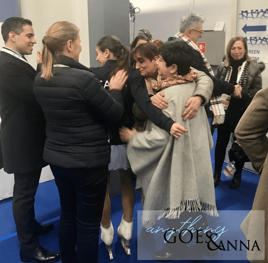 Franca Bianconi, Rosanna Murante and Rebecca Ghilardi hug while other members of the Italian team applaud and smile