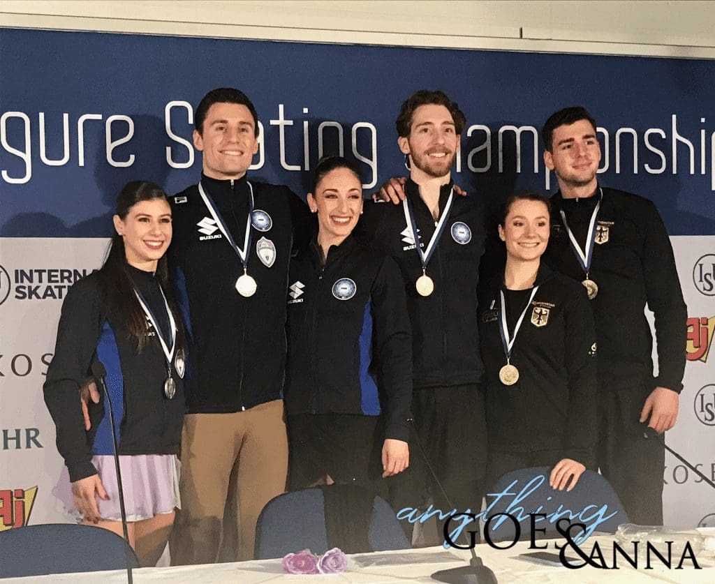 The three medal-winning teams pose for a photo during the press conference after the pairs free skate